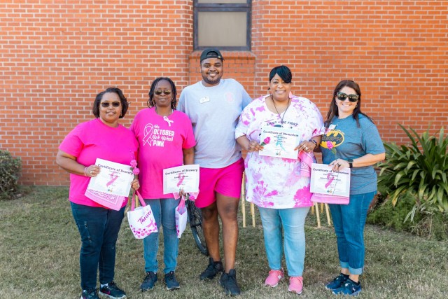 Fort Novosel School Age Center employees receive survivor and memoriam certificates during the 7th annual post-wide motorcycle ride for cancer on Fort Novosel Oct. 18.