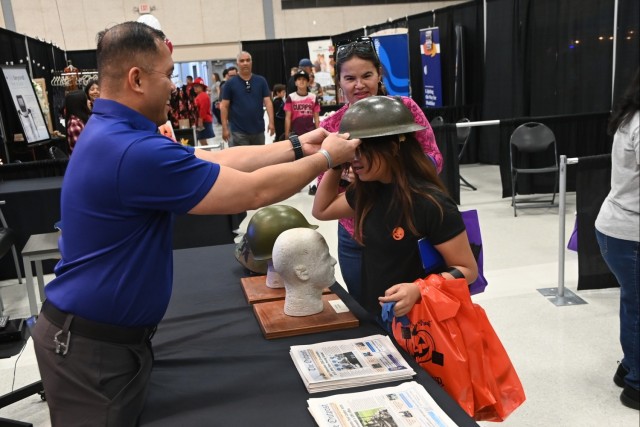 U.S. Army Yuma Proving Ground (YPG) Command Sgt. Maj. Mark Millare (left) and personnel from the YPG Public Affairs Office engaged with eventgoers at the heavily attended Yuma Community Expo on October 19, 2024. YPG&#39;s footprint at the event...