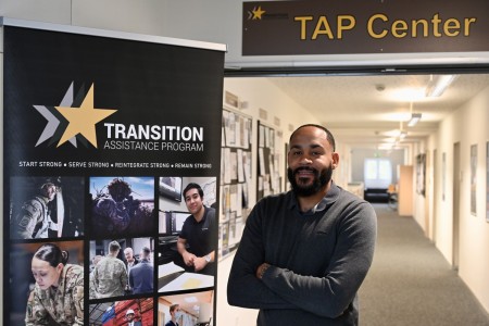 James Hill, U.S. Army Garrison Stuttgart&#39;s transition services manager, stands at the front of the Transition Assistance Program (TAP) hallway in Bldg. 2915, Panzer Kaserne.