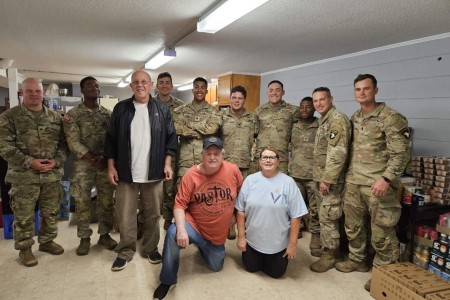 Spc. Randy Stuart (fifth from the right) and his unit, 1st Battalion, 502nd Infantry Regiment, 2nd Mobile Brigade Combat Team, 101st Airborne Division (Air Assault), helped deliver and distribute essential supplies to his hometown during hurricane...