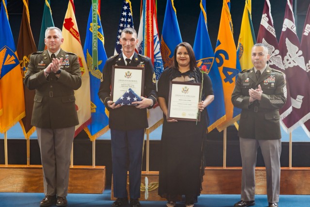Sgt. 1st Class Roaman Johnson stands with his spouse at the Fort Novosel quarterly retirement ceremony inside the Army Aviation Museum Oct. 25.