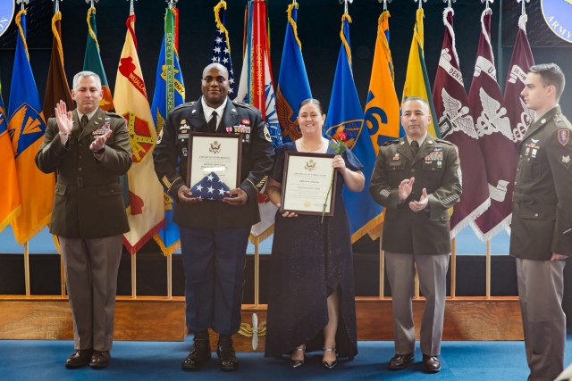Sgt. 1st Class James Tebbe stands with his spouse at the Fort Novosel quarterly retirement ceremony inside the Army Aviation Museum Oct. 25.