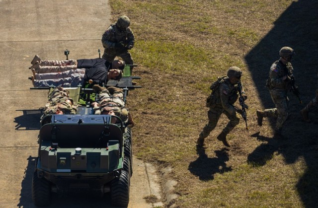 Soldiers of the Maneuver Center of Excellence Experimental Company, 1st Battalion, 29 Infantry Regiment, 316th Cavalry Brigade, employ integrated robotics during a simulated operation as attendees of the Human Machine Integration Summit II view the action, Oct. 17, 2023, at Fort Moore, Ga. The Army has been working with prototypes and performing exercises with new technology including robotic combat vehicles, or RCVs, to help achieve the Secretary of the Army’s goal of “no blood for first contact,” where human machine integrated formations shoulder risk normally assumed by Soldiers. 