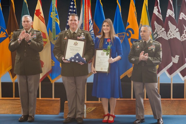 Chief Warrant Officer Four Michel Helland stands with his spouse at the Fort Novosel quarterly retirement ceremony inside the Army Aviation Museum Oct. 25.