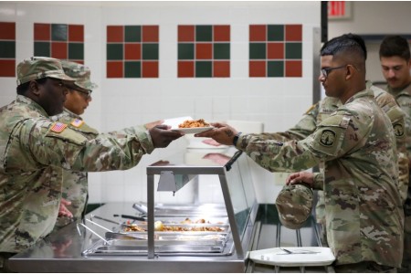 Spc. Vasco Watts serves lunch to Soldiers at the Muleskinner Warrior Restaurant, Fort Drum, New York. Easy food access can enhance military service members’ overall quality of life.