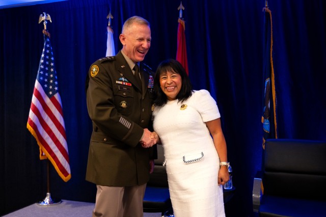 Lt. Gen. Douglas A. Sims II, director for the Joint Staff, congratulates Monica Bassett, founder and CEO of Stronghold Food Pantry, during the Fisher House Foundation and Military Times Foundation’s presentation of grant awards Oct. 23 in...