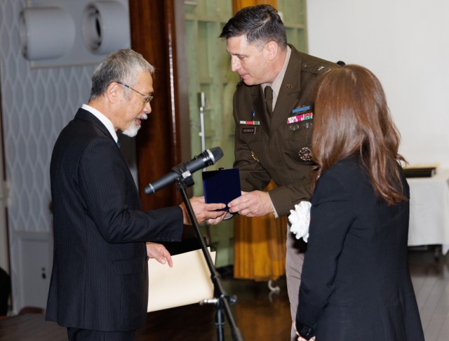 Tsuyoshi Sugahara, left, an engineer technician for the Directorate of Public Works, receives a commemorative gift from Maj. Gen. Dave Womack, commander of U.S. Army Japan, during a length-of-service ceremony at Camp Zama, Japan, Oct. 29, 2024. The ceremony recognized 250 local employees for their nearly 6,000 years of combined service to U.S. Forces Japan.