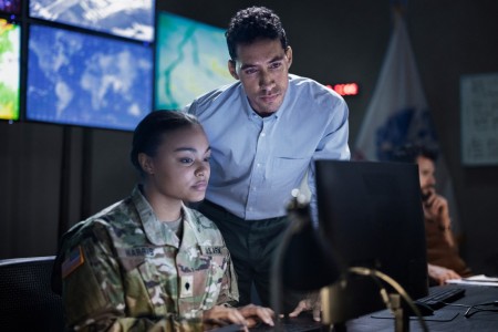 An Army Civilian works with an Army Soldier.