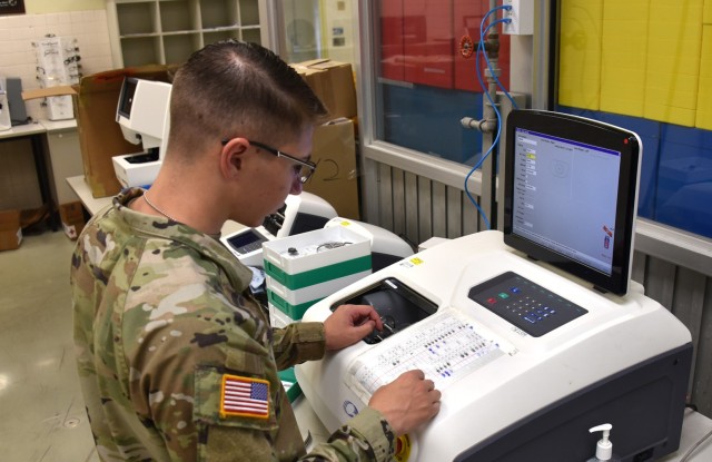 Soldier works in the USAMMC-K optical laboratory