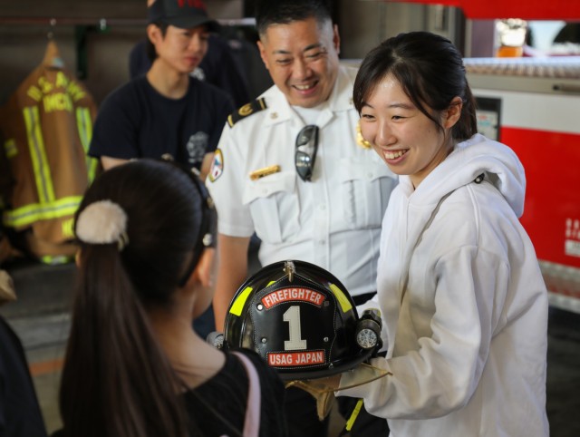 Yui Kajita, right, daughter of Shinji Kajita, district fire chief, receives an in-depth look of her father&#39;s workplace at Fire Station 1 during the &#34;Bring Your Kids to Work Day&#34; event at Camp Zama, Japan, Nov. 4, 2024. Dozens of...