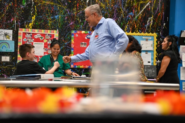 IMCOM leader shares a fist bump with a student while visiting the School Age Services facility at Āliamanu Military Reservation, Hawaii, Monday, Nov. 4, 2024. The visit highlighted child and youth programs across the garrison.