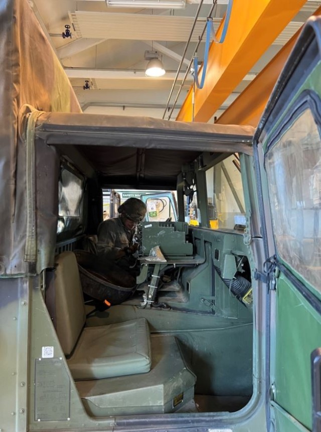 A Soldier from 207th Military Intelligence Brigade inspects a military vehicle at Caserma Ederle, Italy
