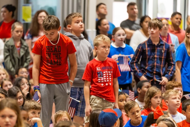 Students stand during the Armed Forces Medley inside the Ellis D. Parker Elementary School cafeteria on Fort Novosel during the annual Veterans Day Program Nov. 7, 2024.