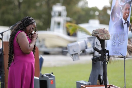 Cordelia Bell, wife of Staff Sgt. Dante Bell, takes a moment in front of Bell’s battle cross during a unit memorial ceremony for Bell who died last month in a training incident. The ceremony, held on November 3, 2024, honored Bell and highlighted his service with his family and Brig. Gen. Michael Shanley, Commanding General, 85th U.S. Army Reserve Support Command in attendance.

(U.S. Army Reserve photo by Anthony L. Taylor)