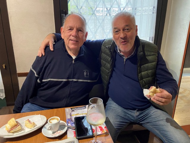 Robert Hansen, left, poses for a picture with a friend, while getting a coffee in a local bar.