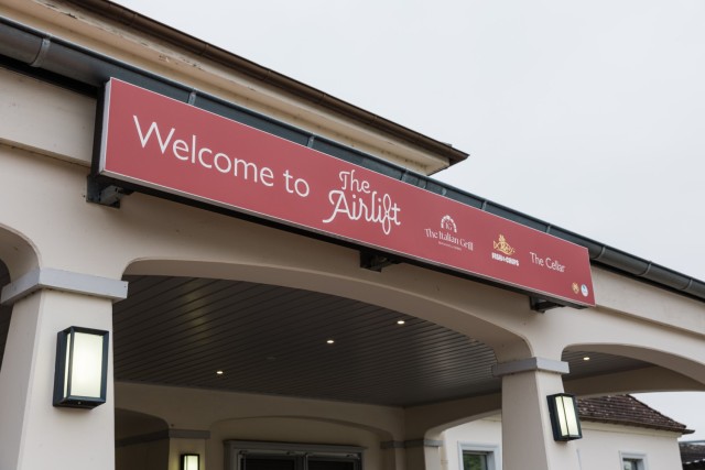 A photo of the new sign above The Airlift is debuted at the official grand opening of The Italian Grill on Clay Kaserne Nov. 7, 2024. (Wiesbaden FMWR Photo by Travis Thurston)