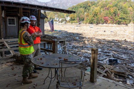 Maj. Brittany Hine, U.S. Army Corps of Engineers, speaks with Justin Gibson, a member of Task Force Debris, while assessing storm debris along the lakefront at Lake Lure, North Carolina, Oct. 26, 2024. The U.S. Army Corps of Engineers is...