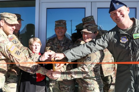 U.S. Army, Air Force, and civilian personnel prepare to cut the ribbon at the unveiling ceremony for the Network Enterprise Center (NEC) new Information Systems Facility (ISF), Nov. 6, 2024, at Joint Base Lewis-McChord, Washington. The facility...