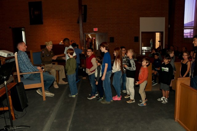 Young congregants at U.S. Army Yuma Proving Ground&#39;s Halo Chapel greet 103-year-old World War II veteran Jimmy Robinson on November 10, 2024. “I know this could be one of the last opportunities for kids to meet a World War II veteran,&#34;....