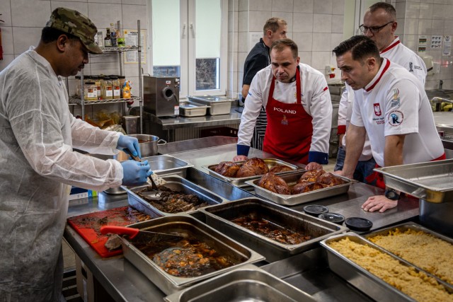 Spc. Feagiai Konelio of the 91st Brigade Engineer Battalion, slices freshly roasted beef in front of Polish Army culinary professionals during a Polish and American personnel cross-training workshop on holiday meals at Bolesławiec, Poland, on Nov. 5, 2024. Polish culinary experts and U.S. Army culinary specialists worked side-by-side to prepare classic holiday dishes, bridging cultural divides through shared flavors and traditions.