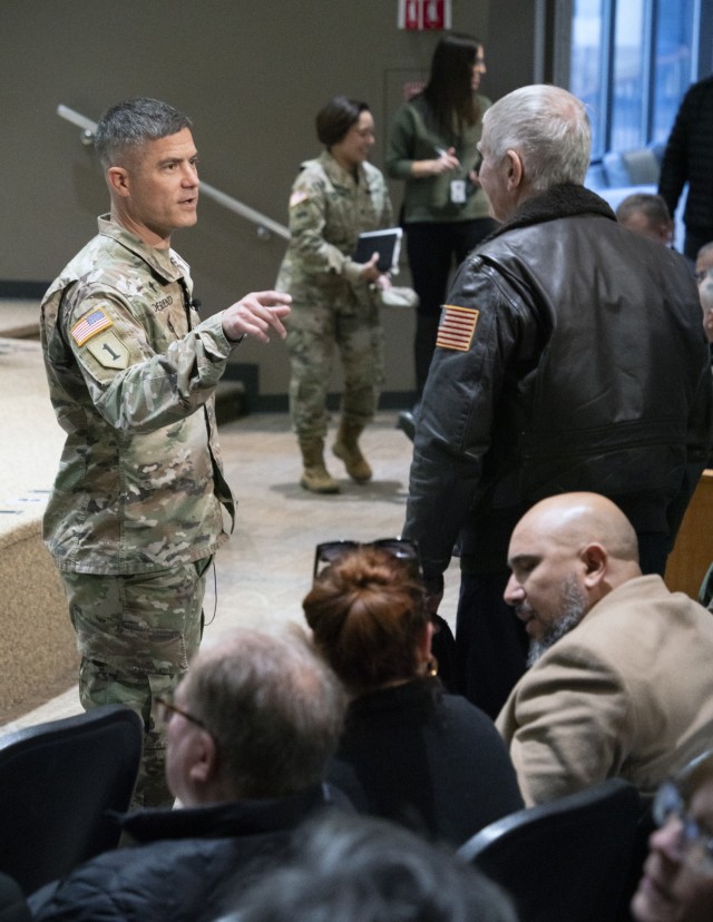 Lt. Col. Michael DeRienzo, chaplain for the U.S. Army Tank-automotive and Armaments Command, talks with an attendee of the suicide prevention and awareness session at the Detroit Arsenal.