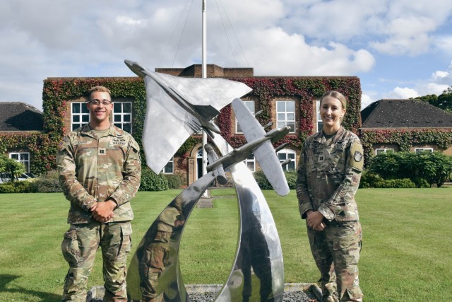 Capt. Anthony Cupit, 1st Space Brigade chief of space operations, left, and Capt. Paulina Montgomery, 1st Space Brigade Strategic Initiatives chief, right, visit the United Kingdom&#39;s Multi-Role Space Squadron at Royal Air Force Base...