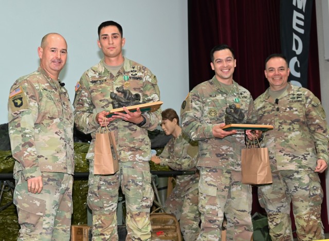 Col. Aristotle Vaseliade (left) and Command Sergeant Major Victor Laragione (right) present trophies to Sgt. 1st Class Kenneth Cavender and Sgt. 1st Class Patrick Vela, US Army Medical Center of Excellence 2024 winning team Best...