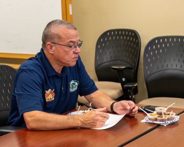 ILSC Executive Director Mark Colley, who served as a judge, carefully considers entries at the Nov. 13, 2024 TACOM chili cookoff.