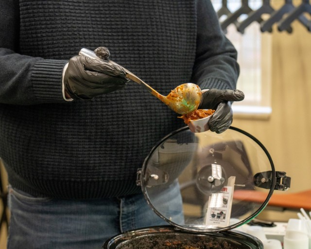 An attendee scoops chili during the Nov. 13, 2024 chili cookoff at the Detroit Arsenal.