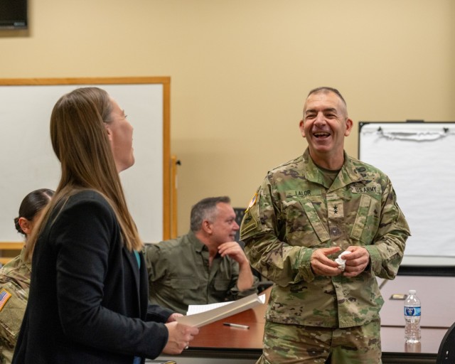 Adelle Ponce, deputy chief of staff resource management, and Maj. Gen. Michael B. Lalor share a laugh during the Nov. 13, 2024 TACOM chili cookoff.