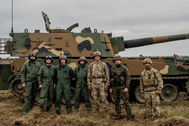 Lt. Col. Douglas Mcdonough, 1st Battalion, 82nd Field Artillery Regiment commander, and Maj. Alistair Fider, 1st Battalion, 82nd Field Artillery Regiment operations officer, meet with Polish Land Forces Maj. Jarosław Skiczewski, 2nd Battalion,...