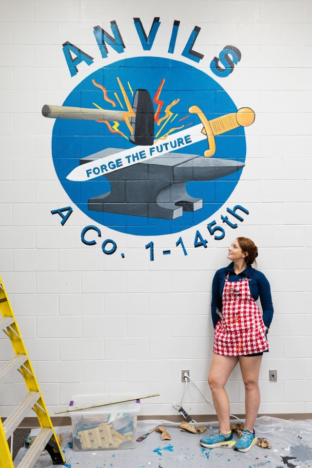 Carolyn Brown, Fort Novosel spouse and local artist, completes her work on an updated mural of the A Co. 1-145th logo in an Aviation CCC classroom on Fort Novosel Nov. 20.