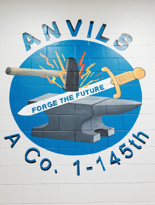 Carolyn Brown, Fort Novosel spouse and local artist, paints an updated mural of the A Co. 1-145th logo in an Aviation CCC classroom on Fort Novosel Nov. 20.