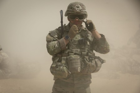 U.S. Army Sgt. Jonathan Shubert, an infantryman assigned to Cherokee Company 1st Battalion, 121st Infantry Regiment, Task Force Commando, adjusts his advanced combat helmet in preparation to fire during a weapons qualification in the U.S. Central Command’s area of operations as part of a military-to-military partnership training exercise, Jade Chameleon, July 22, 2024. (U.S. Army photo by Staff Sgt. Mahsima Alkamooneh)