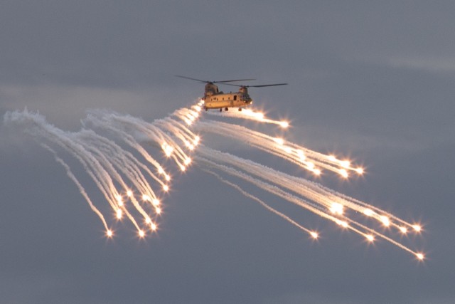 A CH-47 Chinook helicopter, operated by Soldiers assigned to the 1st Combat Aviation Brigade, fires flares on Grafenwoehr Training Area, Germany, Aug. 4, 2021. Soldiers assigned to 1st CAB from Fort Riley are currently on rotation in Germany to...