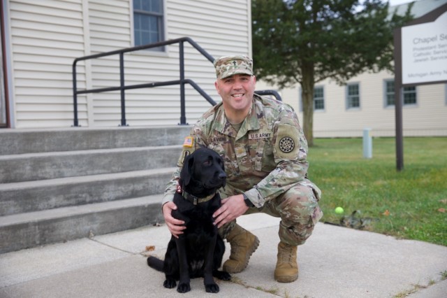 Penny, a therapy dog with the Michigan Army National Guard, provides emotional support to Soldiers during training exercises and events at Fort Custer, November 2024. Penny works alongside Chaplain Adam Lavigne to foster resilience and well-being among service members.. (U.S. Army National Guard photo by 2nd Lt. Paige Bodine)