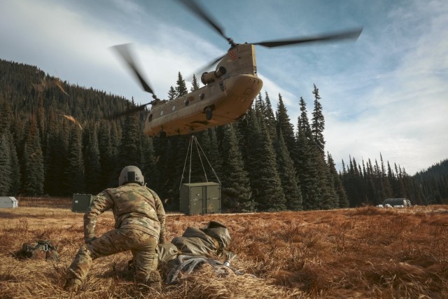 U.S. Soldiers with 1st Battalion, 168th Aviation Regiment (General Support Aviation Battalion), Washington National Guard, attach a cargo hook to a CH-47 Chinook during sling-load operations near Mount Rainier, Wash., Oct. 25, 2024. Washington National Guard aviation assets were activated Oct. 25-27 to support the U.S. Navy in its recovery of an EA-18G Growler fighter jet. (U.S. National Guard photo by Adeline Witherspoon)