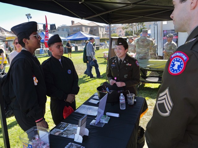 Capt. Christine Kim, an Army Reserve human resources manager, speaks with Navy JROTC cadets during San Francisco Fleet Week 2024 on Oct. 11, 2024. Events such as this help the service attract a high-quality workforce. 
 