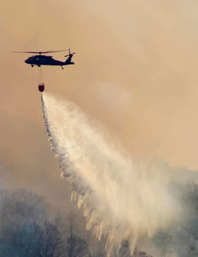 A New York Army National Guard UH-60M Black Hawk helicopter dumps water on the 5,200-acre Jennings Creek Fire in Greenwood Lake, New York, Nov. 15, 2024, while fighting the wildfire on the New York-New Jersey border in Orange County. New York Army...