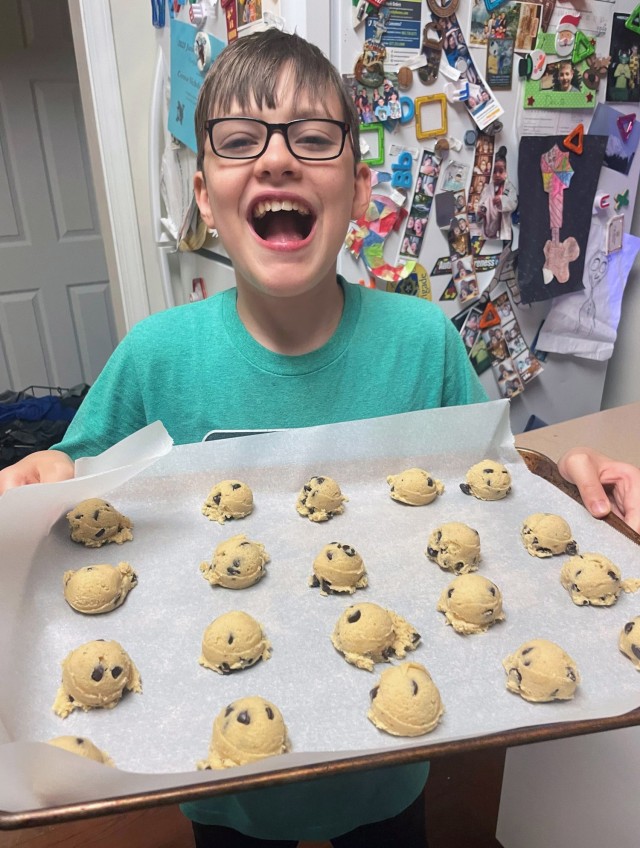 Colin Messenger, 13, son of Lt. Col. Tony Messenger, 3rd Squadron commander, Second Security Force Assistance Brigade, Fort Liberty, North Carolina, helps make FORGE cookies at Fort Jackson,  South Carolina, Oct. 17, 2023. Every Basic Combat Training cycle ends with a field training exercise called the FORGE. Messenger's wife, Amy, and their sons make the cookies for the team to be handed out after 48 hours of continuous operations culminating with the Night Infiltration Course. Each drill sergeant crawled under live fire and barbed wire with the trainees, and each drill sergeant was greeted with a bag of cookies as a morale booster at the mid-point of the event. (Courtesy photo)