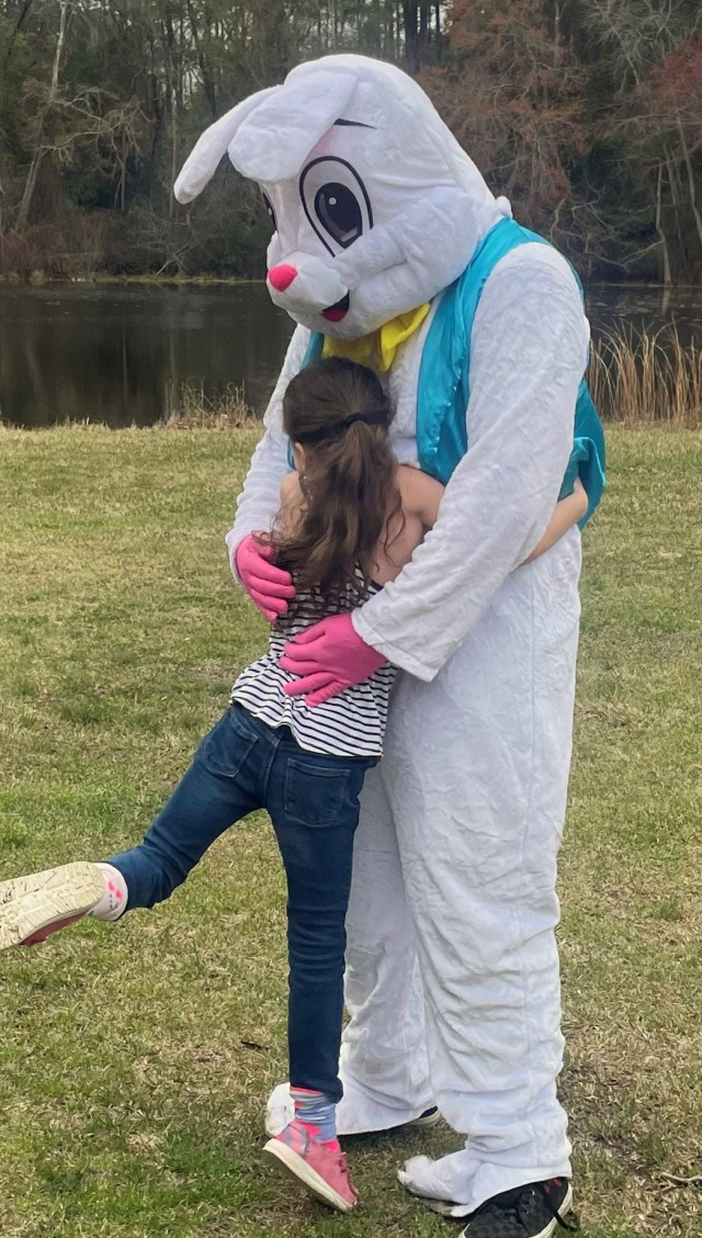 Liam Messenger, 15, son of Lt. Col. Tony Messenger, 3rd Squadron commander, Second Security Force Assistance Brigade, Fort Liberty, North Carolina, receives a hug from a military family member during an Easter family event on Fort Jackson, South Carolina, March 23, 2024. The family and volunteers hosted egg hunts by age group and cooked a lunch. (Courtesy photo)