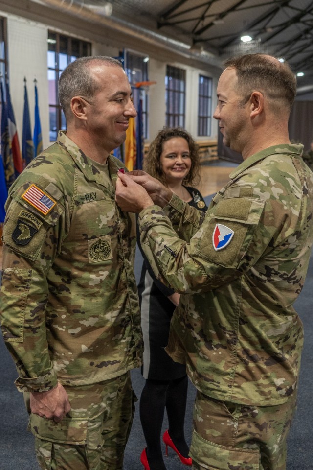 Col. Jesse Chace, right, commander of the U.S. Army Garrion Poland, pins Command Sgt. Maj. Kirk L. Ray, left, outgoing senior enlisted advisor, with the legion of merit for his dedication to the garrison prior to the change of responsibility...