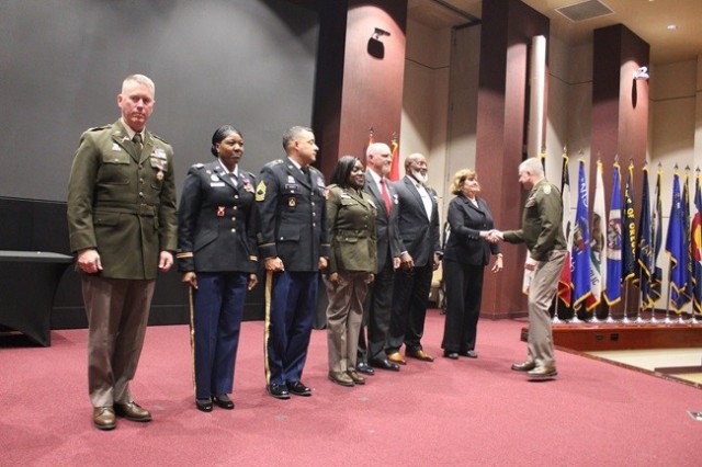 Lt. Gen. Chris Mohan, Army Materiel Command deputy commanding general and acting commander, congratulates the seven honorees Monday at the Redstone Arsenal quarterly retirement ceremony in Bob Jones Auditorium. From left are Col. Ronnie Preston,...