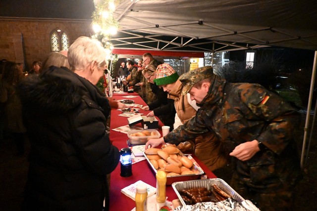 German soldiers and spouses sell bratwursts, glühwein, kinder punsch and cookies at the Christkindlmarkt after the German Christmas Service Dec. 7 outside Memorial Chapel on Fort Leavenworth, Kansas. Photo by Sean Bergosh/Fort Leavenworth...