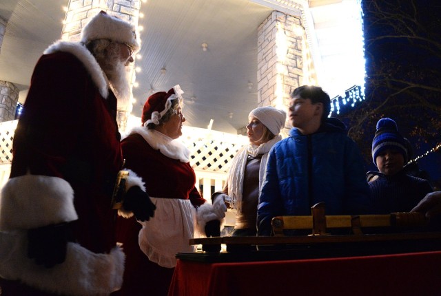 Santa and Mrs. Claus join the Gardner family — Kimberly Gardner, 12-year-old Jordan and 8-year-old Grayson — in celebrating the lighting of Zais Park Dec. 6 at Fort Leavenworth, Kansas. The Gardners, whose husband/father Capt. Randy Gardner is...