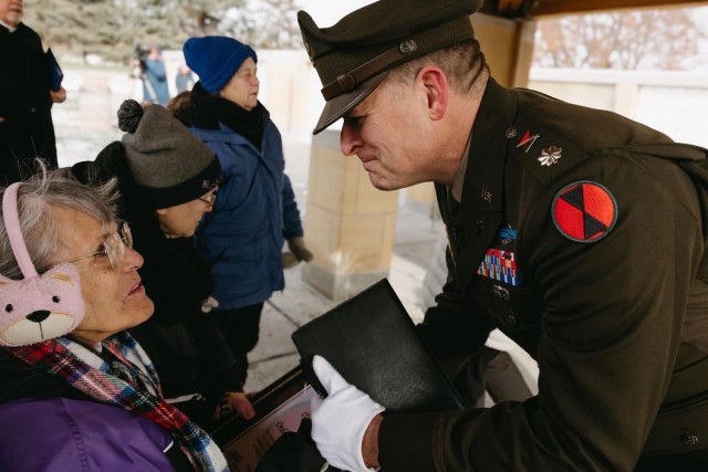The 7th Infantry Division Chaplain Lt. Col. Matthew Madison presents the Order of the Bayonet award to the niece of Cpl. William Colby, a 7th Infantry Division Soldier killed in combat in the Korean War, during a repatriation ceremony held at Fort...