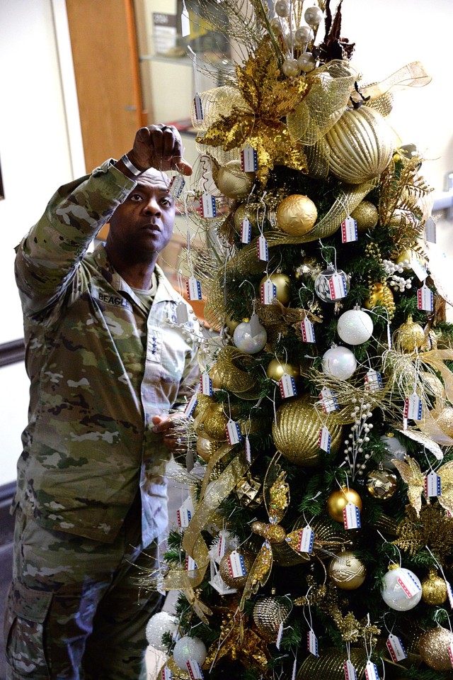 Combined Arms Center and Fort Leavenworth Commanding General Lt. Gen. Milford Beagle Jr. adds the name of a fallen service member to the Tree of Honor Dec. 10, 2024, in the atrium of the CAC Headquarters building. Photo by Prudence Siebert/Fort...