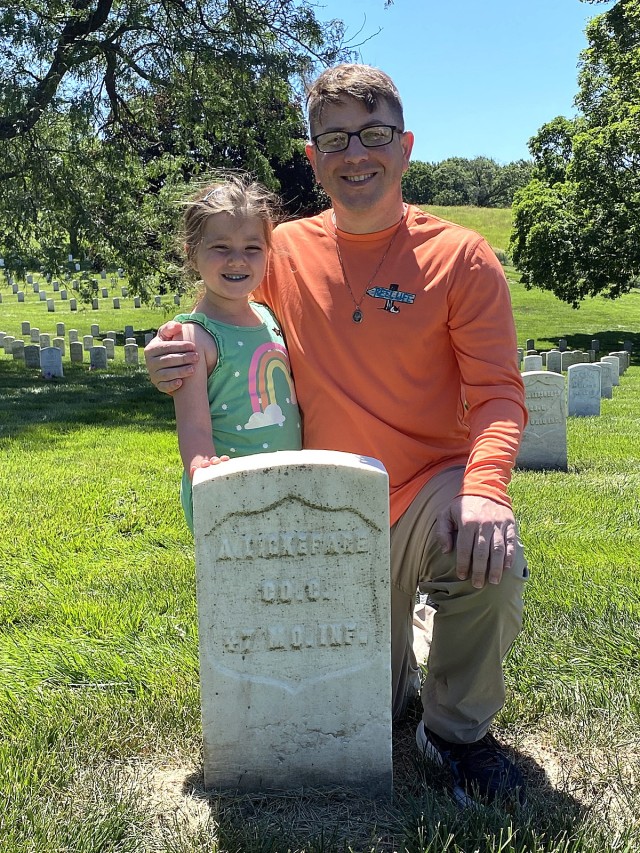 Lt. Col. David Lukefahr and his daughter, Heidi, pose at the grave of his ancestor, Anton Lukefahr (misspelled Lickefare) at the Leavenworth National Cemetery earlier this year (2024) in Leavenworth, Kansas. Submitted photo by Patricia Lukefahr