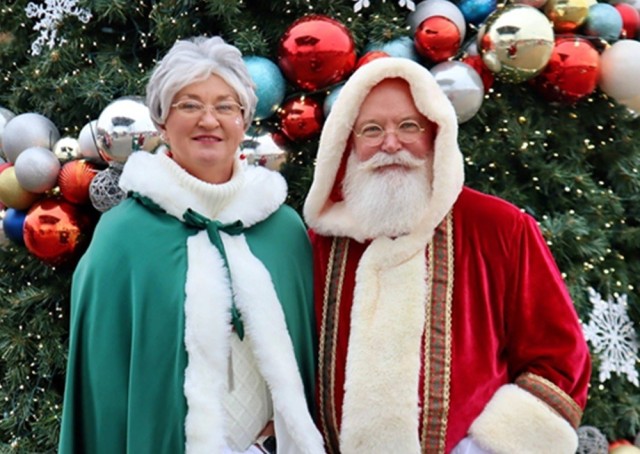 Tracy Ryan and Jeff Martin portray Santa and Mrs. Claus during Winterville at the Redstone Activity Field.