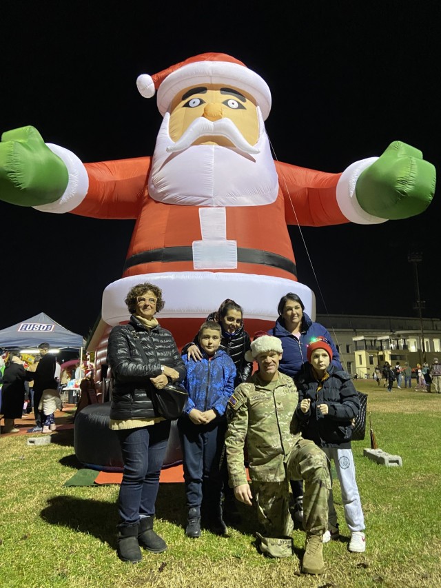 Vicenza for Children guests pose with garrison commander, Col. Scott Horrigan, at garrison tree lighting event Dec. 5.